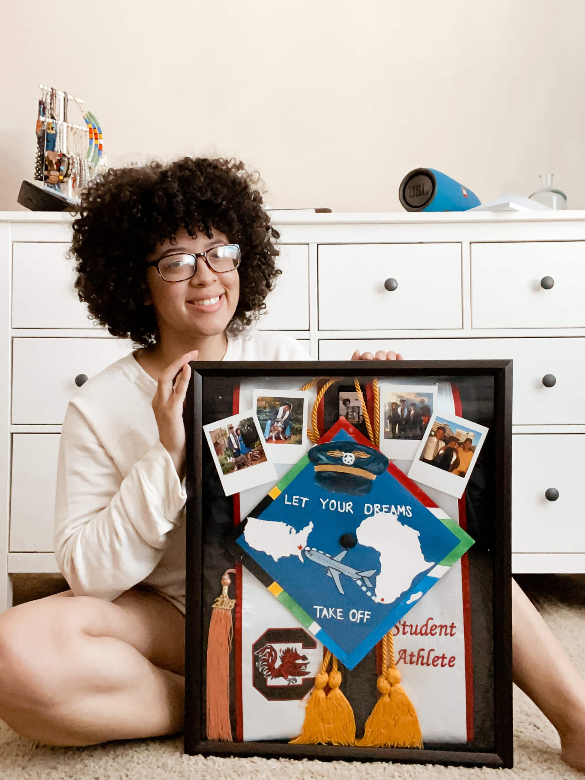 In this blog post, I’m sharing how you can create a DIY Graduation Shadowbox! It is literally so easy to do, and you only need a handful of materials to do it yourself at home. Creating a shadowbox is a great way to treasure your memories from college and also create some fun home décor to keep for years to come. 